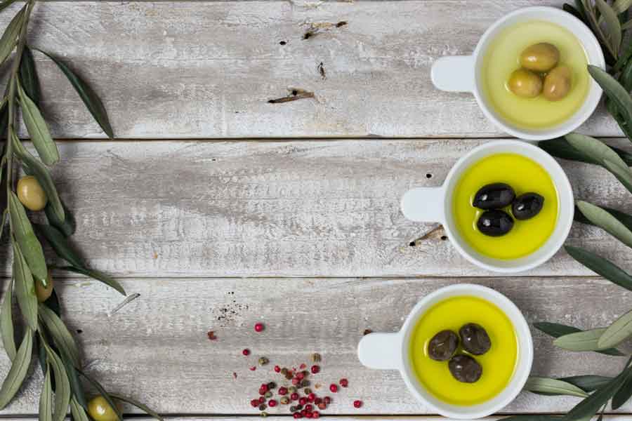 olives in cups with olive oil